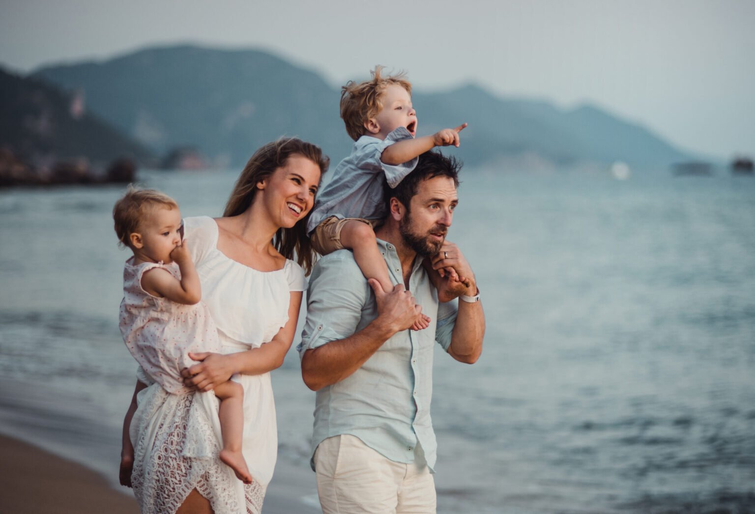 A young family standing together outdoors